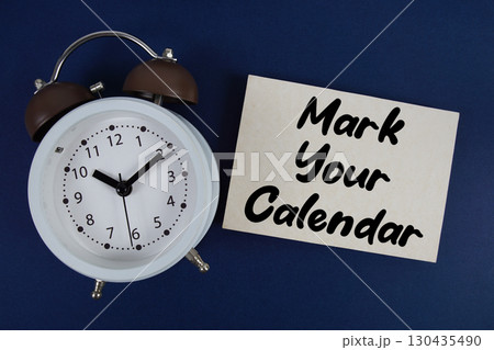 Mark Your Calendar text with alarm clock on blue background 130435490
