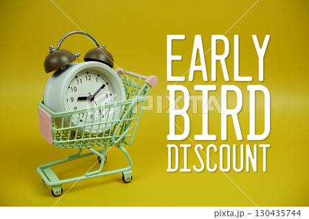 Early Bird Discount text with trolley shopping cart and alarm clock on yellow background 130435744