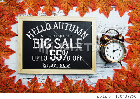 Hello Autumn Big Sale 55% with maple leaf decortaed on wooden background Hello Autumn Big Sale 55% with maple leaf decortaed on wooden background 130435850