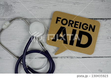 Foreign Aid text with Stethoscope on wooden background 130435923