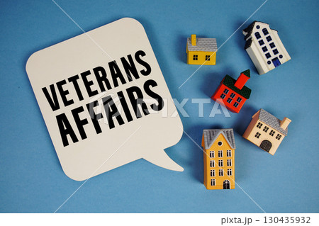 VA Veterans Affairs text with house models on blue background VA Veterans Affairs text with house models on blue background 130435932