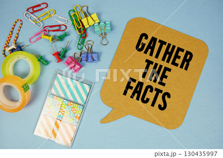 Gather The Facts text with stationery on blue background 130435997