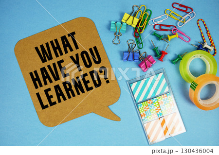 What Have you Learned? text with stationery on blue background 130436004