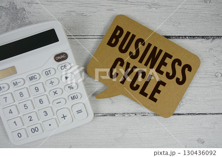 Business Cycle text with calculator on wooden background 130436092