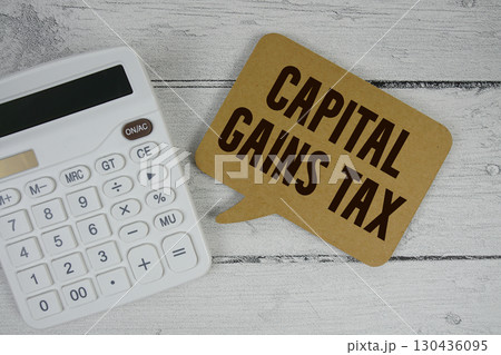 Capital Gains Tax (CGT) text with calculator on wooden background Capital Gains Tax (CGT) text with calculator on wooden background 130436095