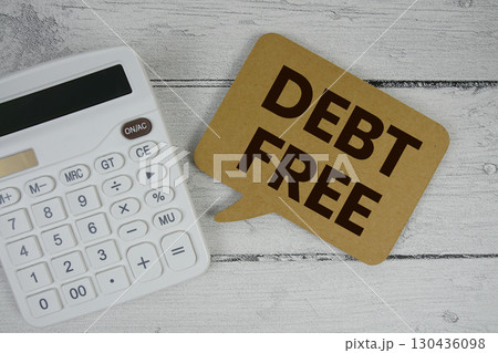 Debt Free text with calculator on wooden background 130436098