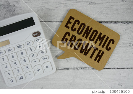 Economic Growth text with calculator on wooden background Economic Growth text with calculator on wooden background 130436100