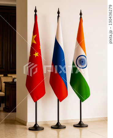 three flags of china, russia and india on a stand in a room against a white wall three flags of china, russia and india on a stand in a room against a white wall 130436279