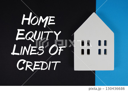 HELOC Home Equity Lines Of Credit text with house models on black background HELOC Home Equity Lines Of Credit text with house models on black background 130436686