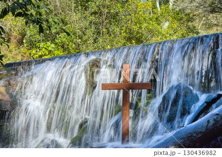 Wooden Cross in a Waterfall 130436982
