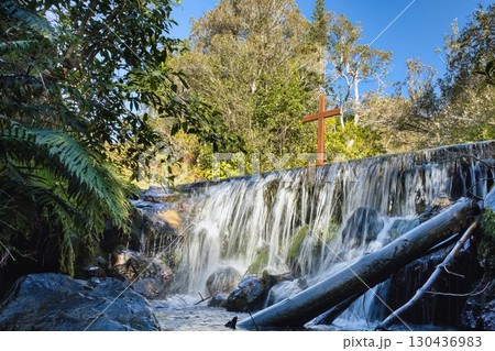 Wooden Cross On Top of Waterfall 130436983
