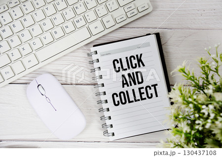 Click and Collect text with keyboard and wireless mouse on wooden background Click and Collect text with keyboard and wireless mouse on wooden background 130437108