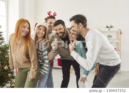 Friends Singing Karaoke Together During A New Year Or Christmas Party At Home 130437332