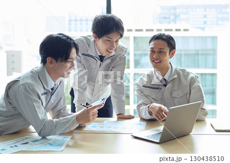 打ち合わせをする作業服姿の男性 130438510