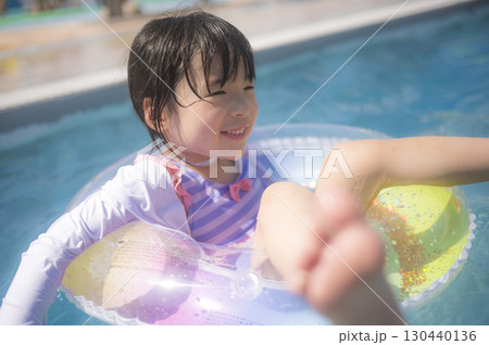 浮き輪でプールに浮かぶ女の子 浮き輪でプールに浮かぶ女の子 130440136