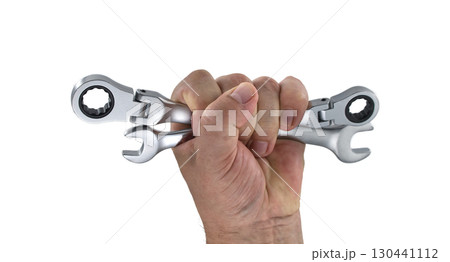 Hand gripping two wrenches isolated on white background Hand gripping two wrenches isolated on white background 130441112