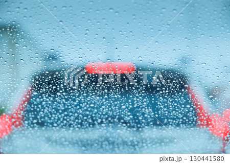 raining season on the road. driving in storm, heavy rain drop windshield, weather in rainy season raining season on the road. driving in storm, heavy rain drop windshield, weather in rainy season 130441580