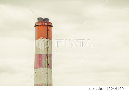large white red stripe industry chimney, hot gas pipe releases against cloudy sky background 130441604