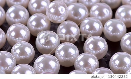 Beautiful arrangement of lustrous pearls on a dark surface creating an elegant background 130442282