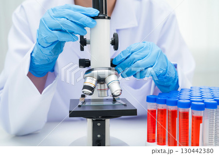 Scientist medical professional use microscope for research in science laboratory. 130442380