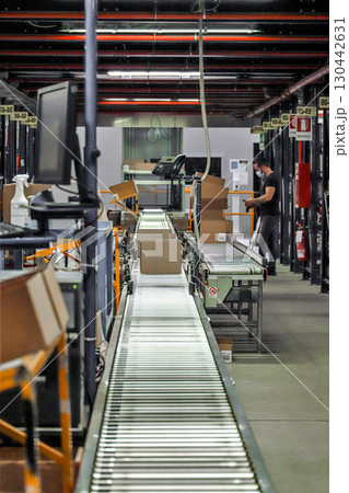 logistic warehouse. packing line in a logistics warehouse. conveyor belt in a modern production line 130442631