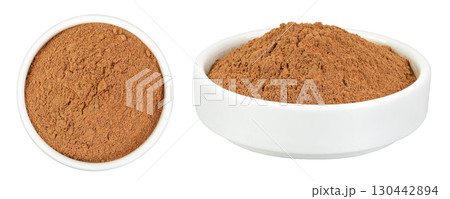 Cinnamon powder in ceramic bowl isolated on white background. Top view. Flat lay 130442894