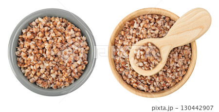Boiled buckwheat in a ceramic and wooden bowl isolated on white background. Top view. Flat lay 130442907
