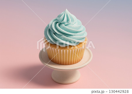 Minimalist single pastel cupcake with blue and pink swirl frosting on soft pink backdrop Minimalist single pastel cupcake with blue and pink swirl frosting on soft pink backdrop 130442928