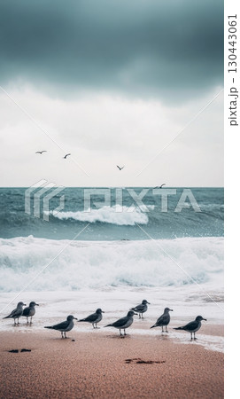 Seagulls gather along the shore under a cloudy sky. Waves crash gently on the sand creating a serene atmosphere. Nature and wildlife coexist beautifully. Generative AI 130443061