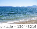 Seascape with the mountains in the background. Sea waves on the beach. Sea, sky and the beach. 130443216