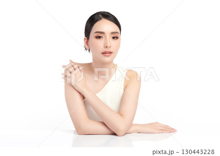 A beautiful young Asian woman with clean, fresh skin against a white background. Skincare, facial treatment, cosmetology, beauty, and spa. An elegant portrait of an Asian woman. A beautiful young Asian woman with clean, fresh skin against a white background. Skincare, facial treatment, cosmetology, beauty, and spa. An elegant portrait of an Asian woman. 130443228