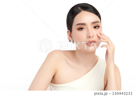 A beautiful young Asian woman with clean, fresh skin against a white background. Skincare, facial treatment, cosmetology, beauty, and spa. An elegant portrait of an Asian woman. 130443231