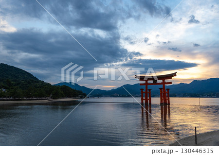 Famous red torii gate of Itsukushima shrine at sunset in Miyajima, Japan 130446315