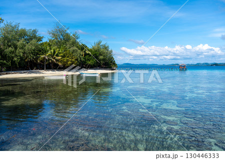 Wooden jetty and boat at Bolilanga Island, Togian archipelago, Sulawesi, Indonesia Wooden jetty and boat at Bolilanga Island, Togian archipelago, Sulawesi, Indonesia 130446333