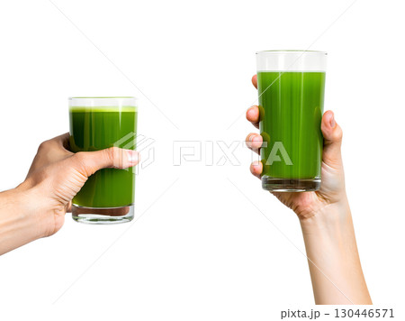 Close-up of hand holding fresh green smoothie with spinach, healthy lifestyle choice isolated 130446571