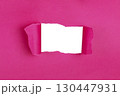 Hole in paper color background damaged ripped 130447931