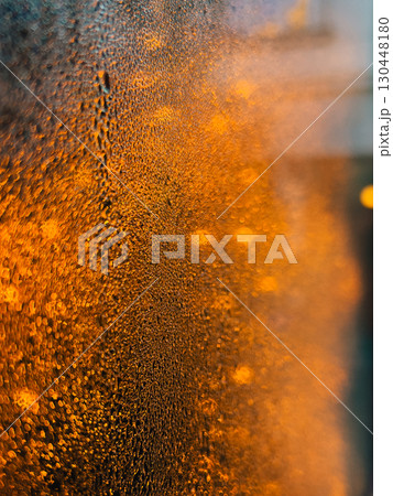 Water droplets clinging to surface reflect warm orange light, creating captivating abstract background with stunning gradient effect and intricate textures that evoke serene atmosphere. Texture shift Water droplets clinging to surface reflect warm orange light, creating captivating abstract background with stunning gradient effect and intricate textures that evoke serene atmosphere. Texture shift 130448180