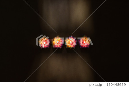 Three Diwali Candles on a Dark Background 130448639