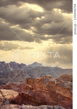 Majestic mountains under a dramatic sky during sunset in a remote desert landscape. Petra, Jordan. 130448704
