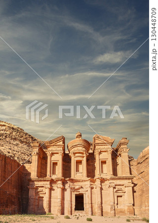 Majestic ancient temple carved into rock in the Jordanian desert under a vibrant sky. Ancient Petra Majestic ancient temple carved into rock in the Jordanian desert under a vibrant sky. Ancient Petra 130448709