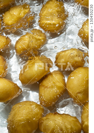 Whole Organic Raw Potatoes In Water Top View, Splash And Ripples. 130450230