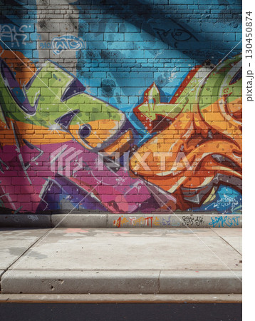 Colorful urban street wall adorned with vibrant graffiti artwork during daylight in a bustling city 130450874