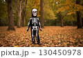 Happy cheerful boy in skeleton costume with basket celebrates Halloween 130450978