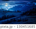 mountainous countryside landscape in spring at night. grassy field on slope of a hill. mountain ridge with snow capped tops in the distance in full moon light. sunny weather with clouds on the sky 130451685