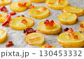 Baked potatoes on baking paper detail 130453332