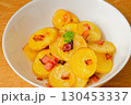Baked sliced potatoes in bowl 130453337