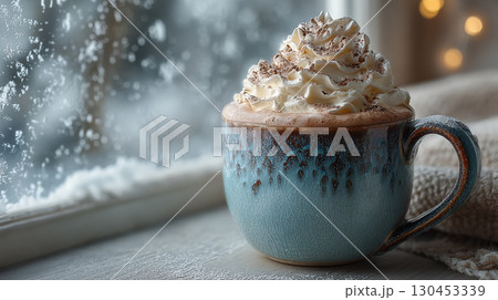 Cozy ceramic mug filled with hot cocoa topped with whipped cream sits by frosty window, evoking warmth and comfort 130453339