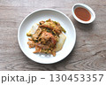 fried seafood with chicken and pork meat couple glass noodles vegetable toping egg yolk dipping sukiyaki sauce on plate 130453357