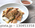 fried seafood with chicken and pork meat couple glass noodles vegetable toping egg yolk dipping sukiyaki sauce on plate 130453358