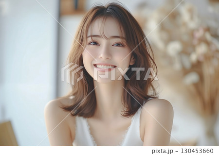 笑顔がかわいい若い女性のポートレート。背景はドライフラワーが飾られた部屋 130453660